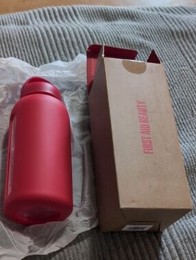 First Aid Beauty Matte Red Travel Bottle with Silicone Sleeve